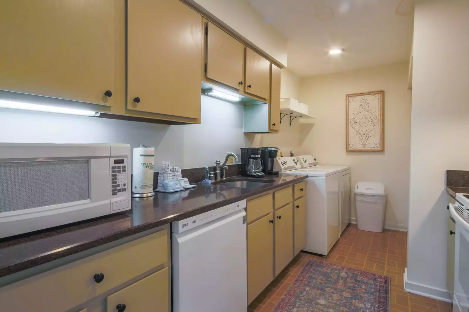 There is a full-sized washing machine and dryer in the kitchen.