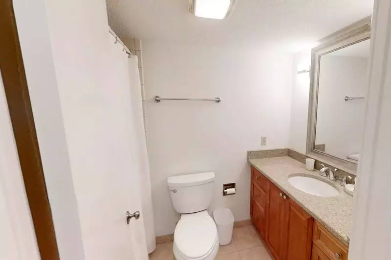 The en suite bathroom features a spacious vanity and a shower/tub combo.
