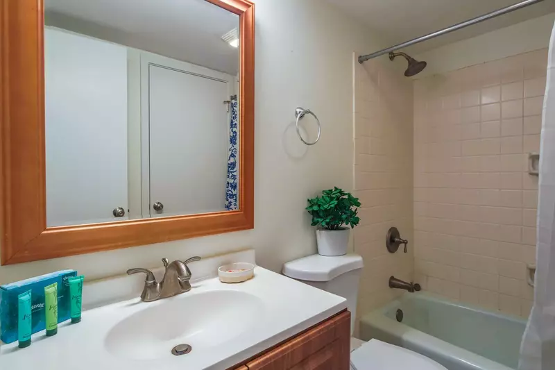 The guest bathroom features a spacious vanity and a shower/tub combo.