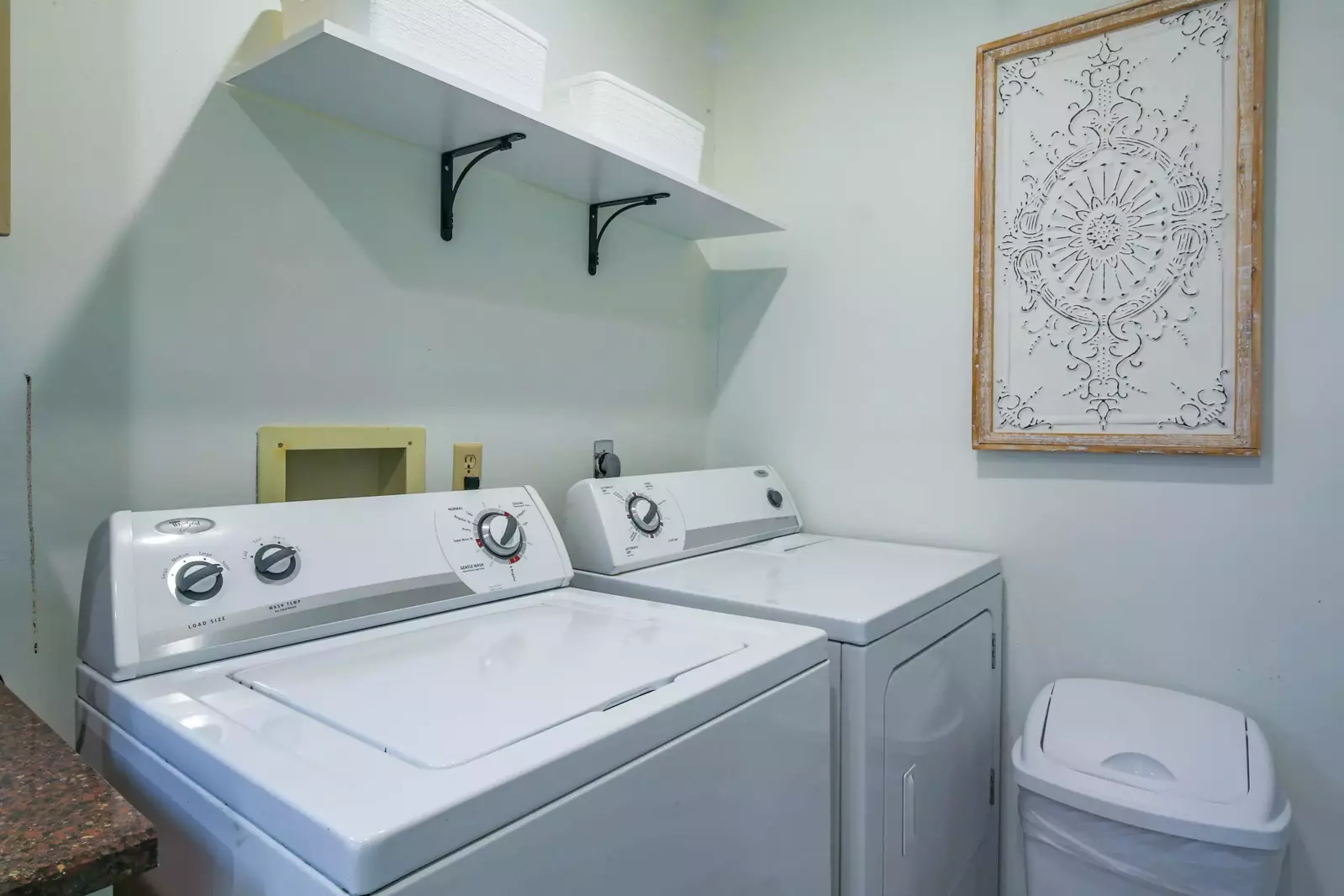There is a full-sized washing machine and dryer in the kitchen.