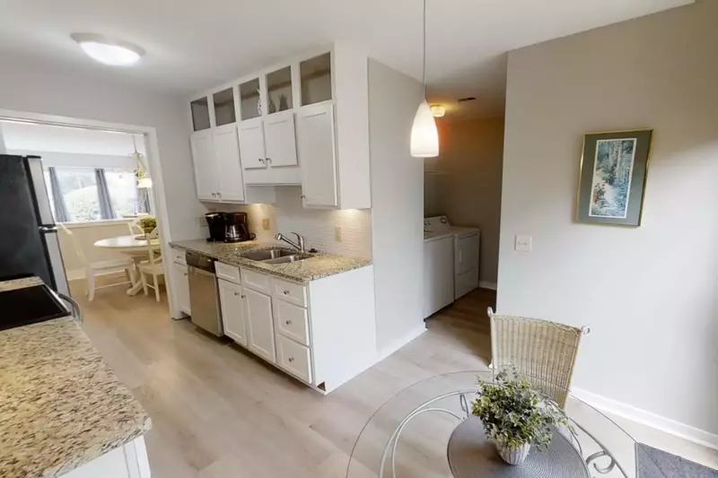 Kitchen with Keurig and drip coffee makers and dinette for 2 opens to full size washer and dryer laundry