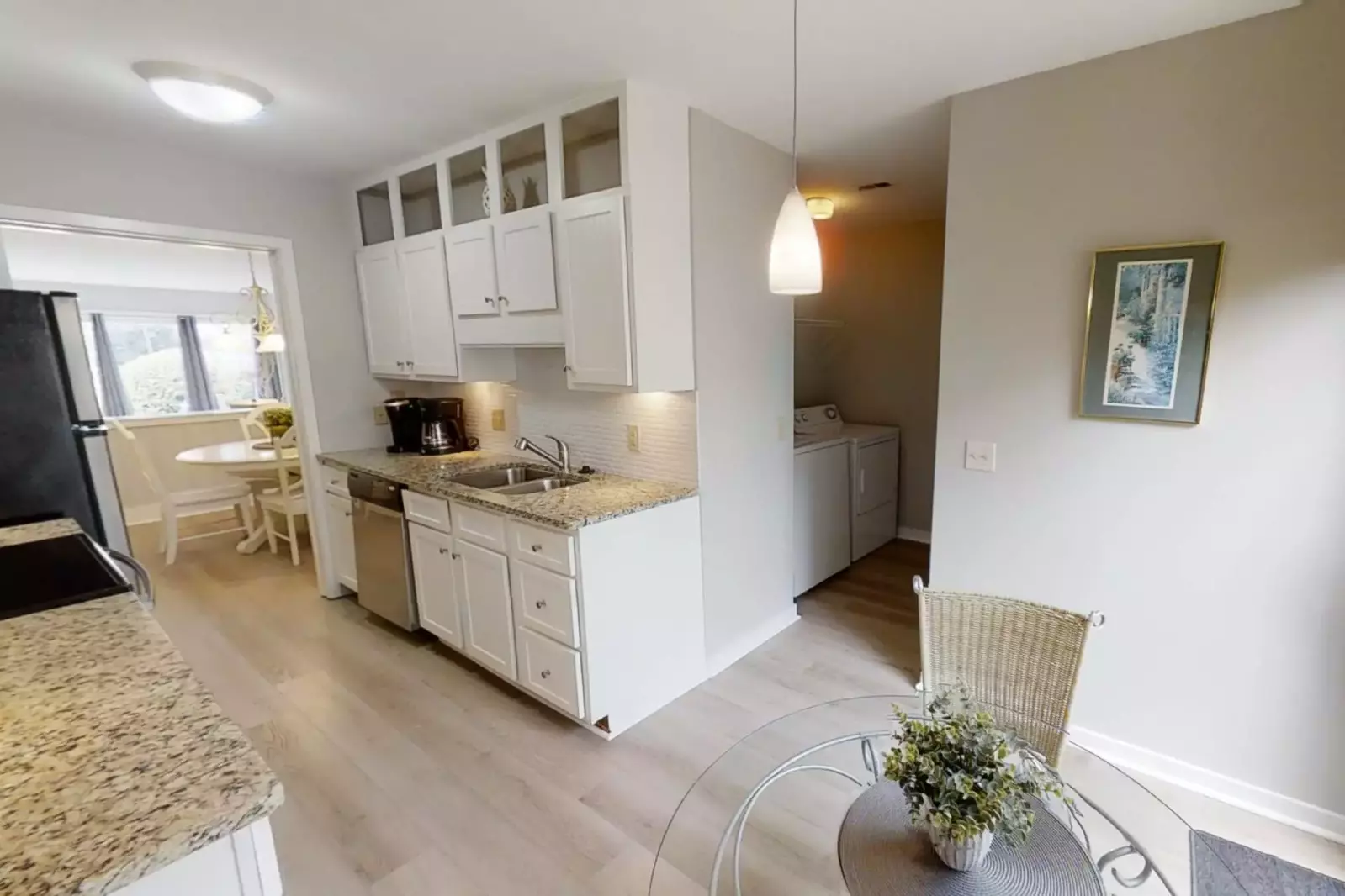 Kitchen with Keurig and drip coffee makers and dinette for 2 opens to full size washer and dryer laundry