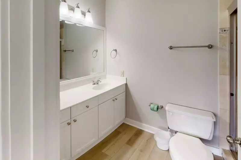 On-Suite Master bathroom with single vanity, large walk in shower and 2 closets