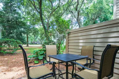 The high top dining table on the back patio has views of the golf course and beautiful Lowcountry trees.