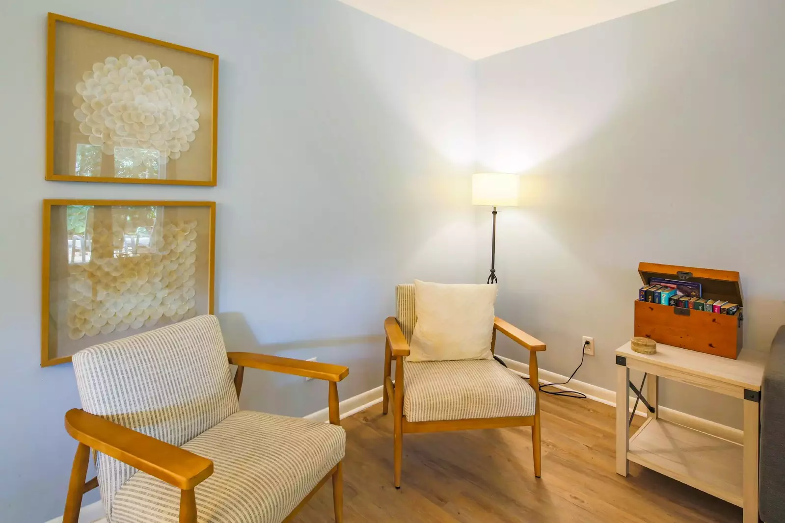 There are also two arm chairs and a floor lamp in the living room.