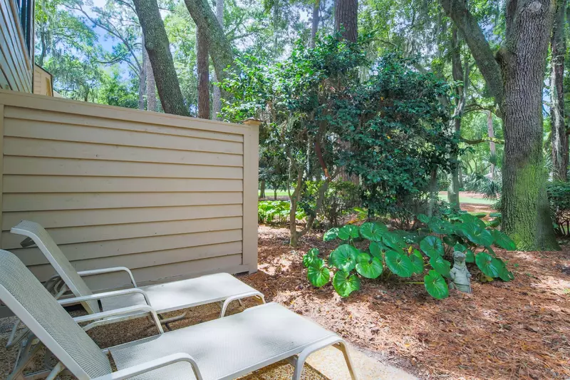 There are two lounge chairs on the back patio.