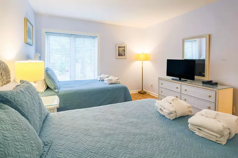 The guest suite also features a dresser, floor lamp and flat screen TV.