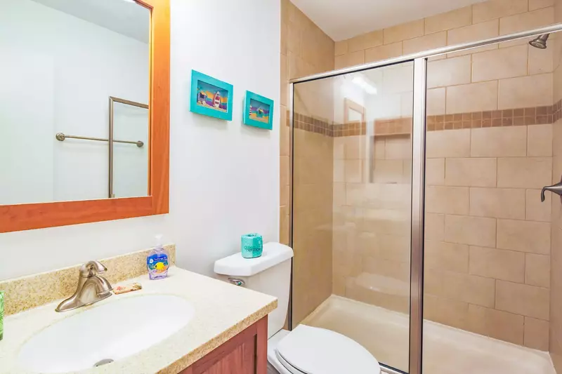 The en suite bathroom also has a tiled, walk-in shower.