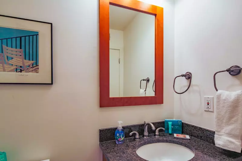 There is a half bathroom on the ground floor near the front door and living room.