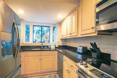 The renovated kitchen features granite counters and stainless appliances.