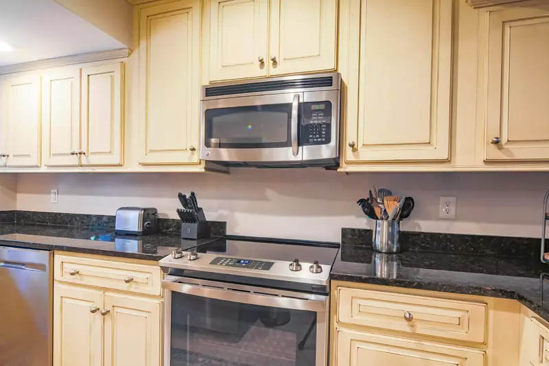 The kitchen features a dishwasher, range, microwave and ample storage space.
