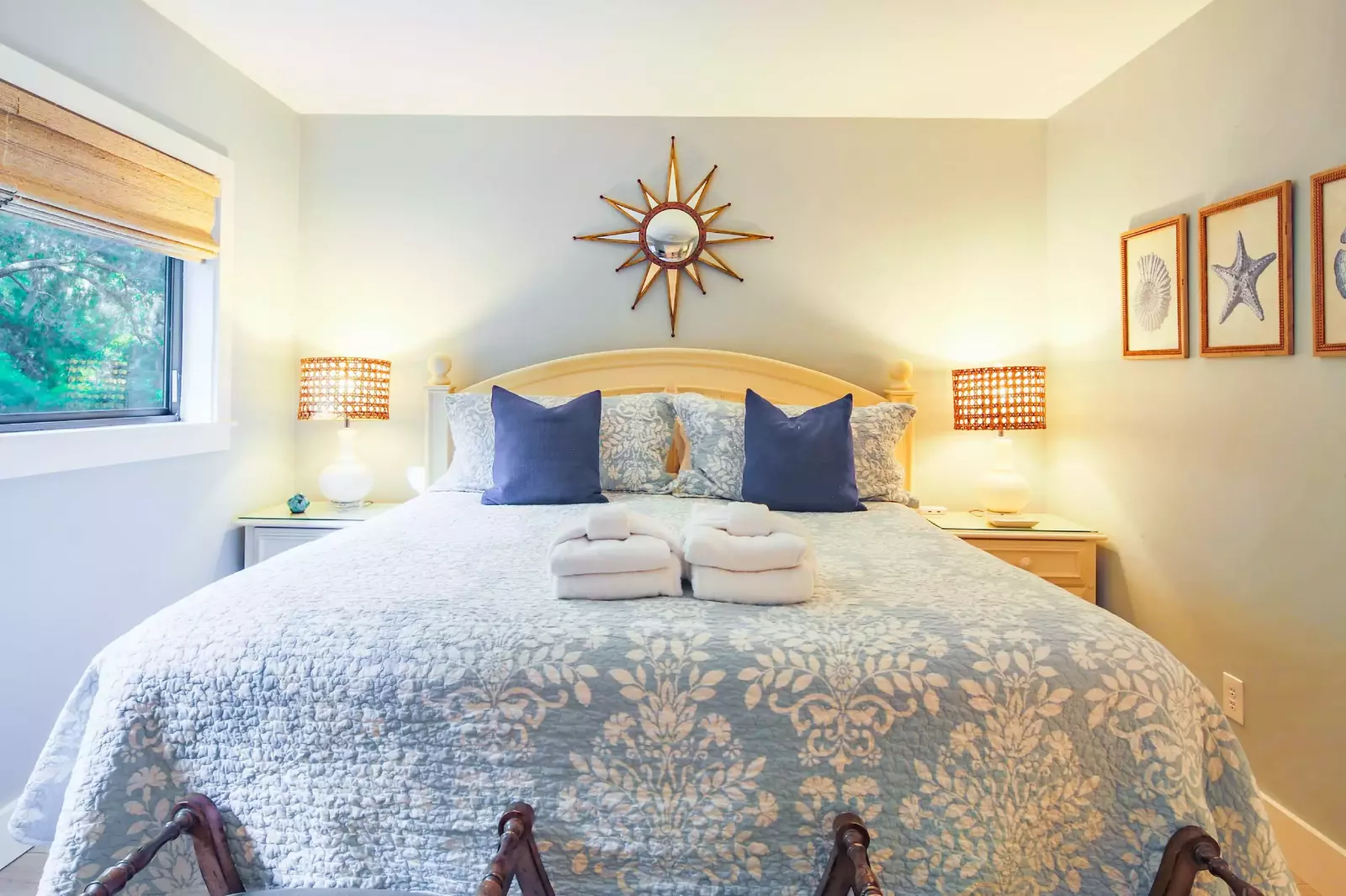 The master suite features a king bed and night stands with reading lamps.