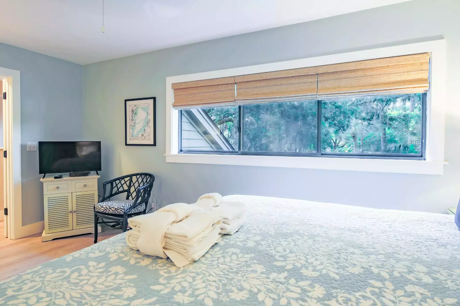 The master suite also has an arm chair, a flat screen TV and views of the lagoon through this large window.