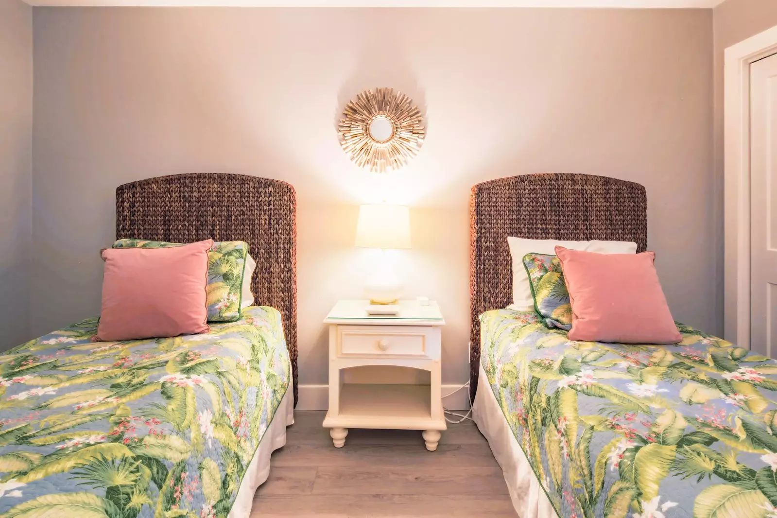 The guest suite features two twin beds and a night stand with a reading lamp.