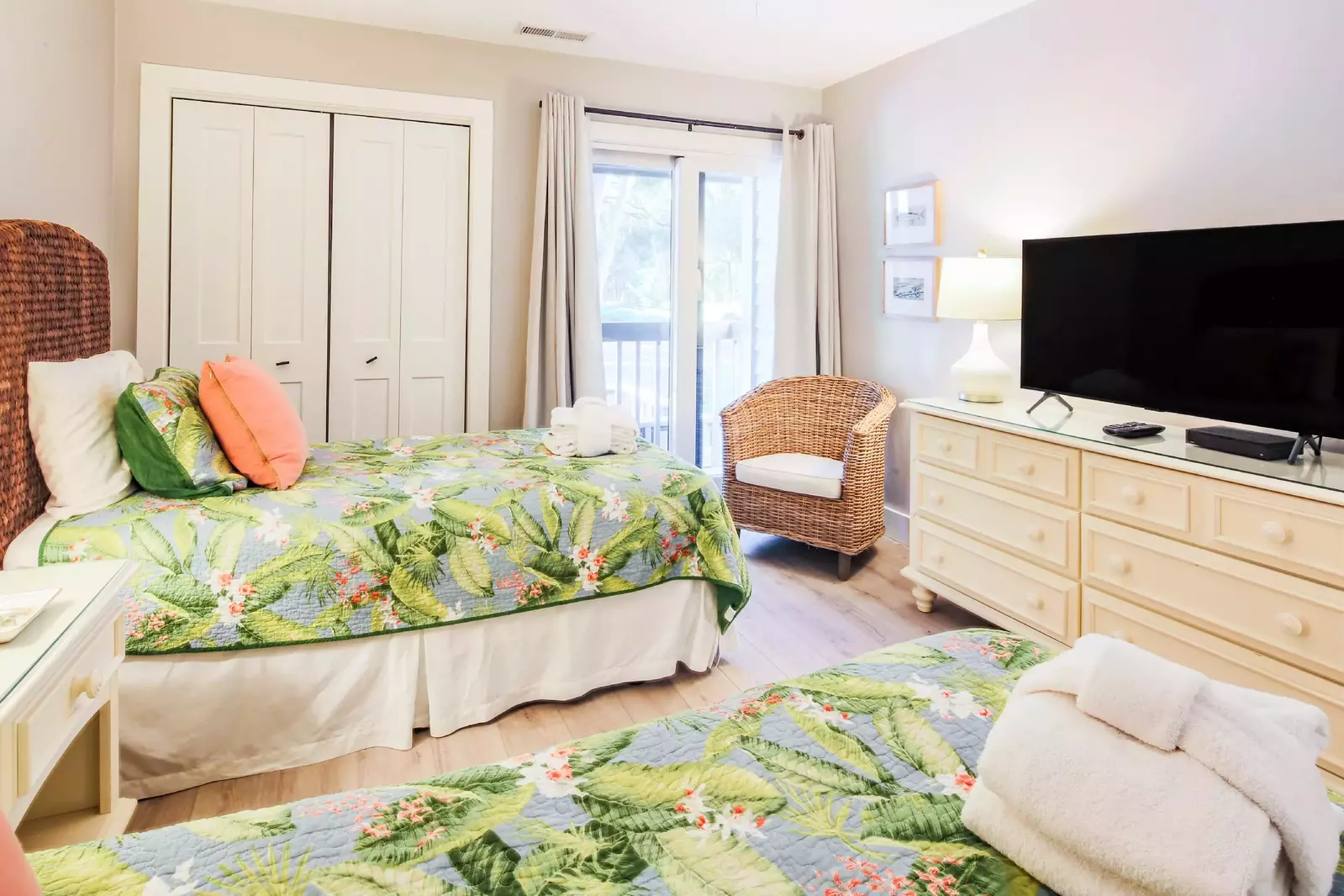 The guest suite also features acess to a private balcony, an arm chair, dresser and flat screen TV.