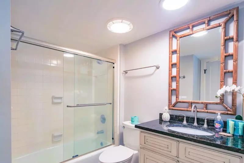 This en suite bathroom with shower/tub combo may also be accessed from the hallway.