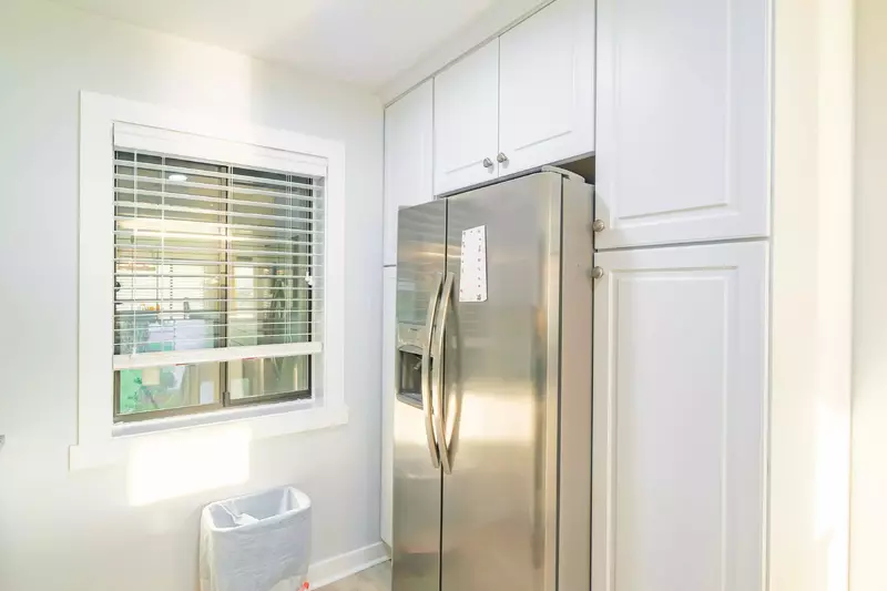 There is also a refrigerator and several cabinets.