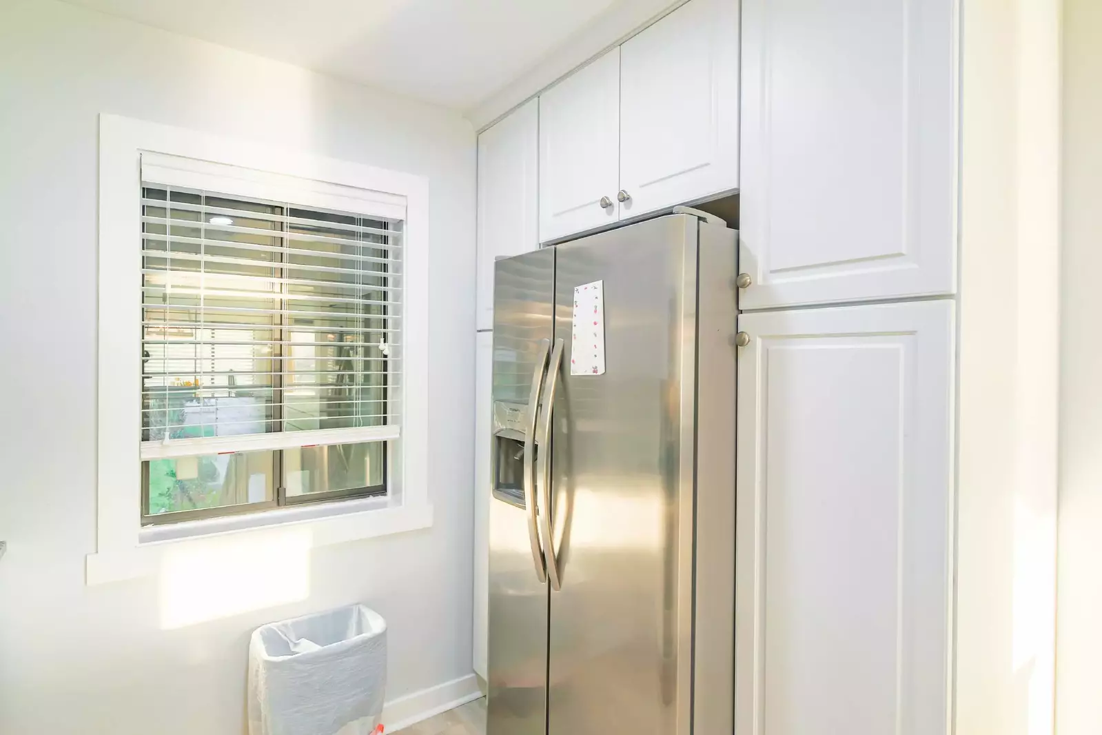 There is also a refrigerator and several cabinets.