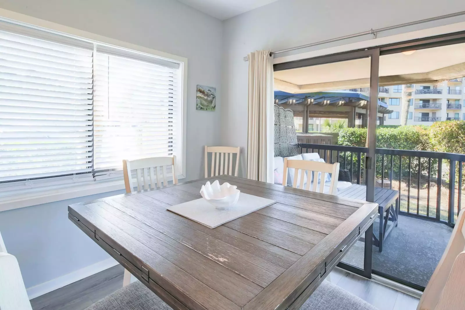 There is a sliding glass door near the dining table that leads to a private covered balcony.