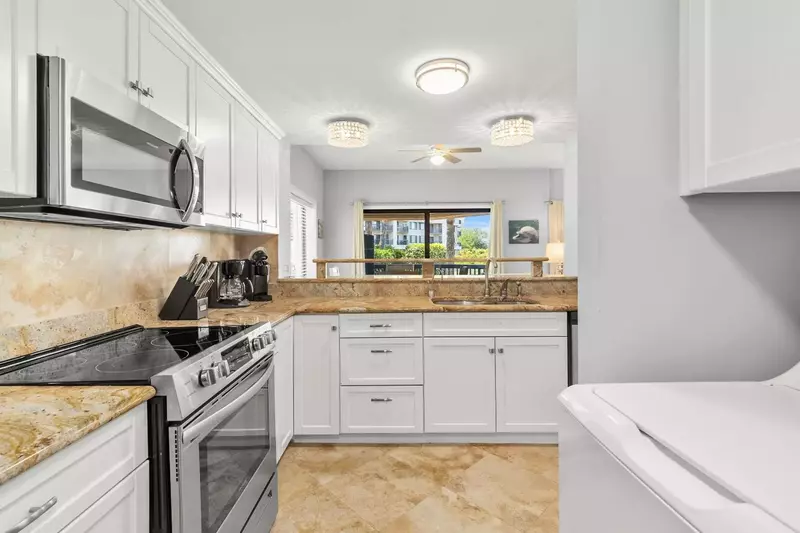 The washing machine and dryer are located near the kitchen.