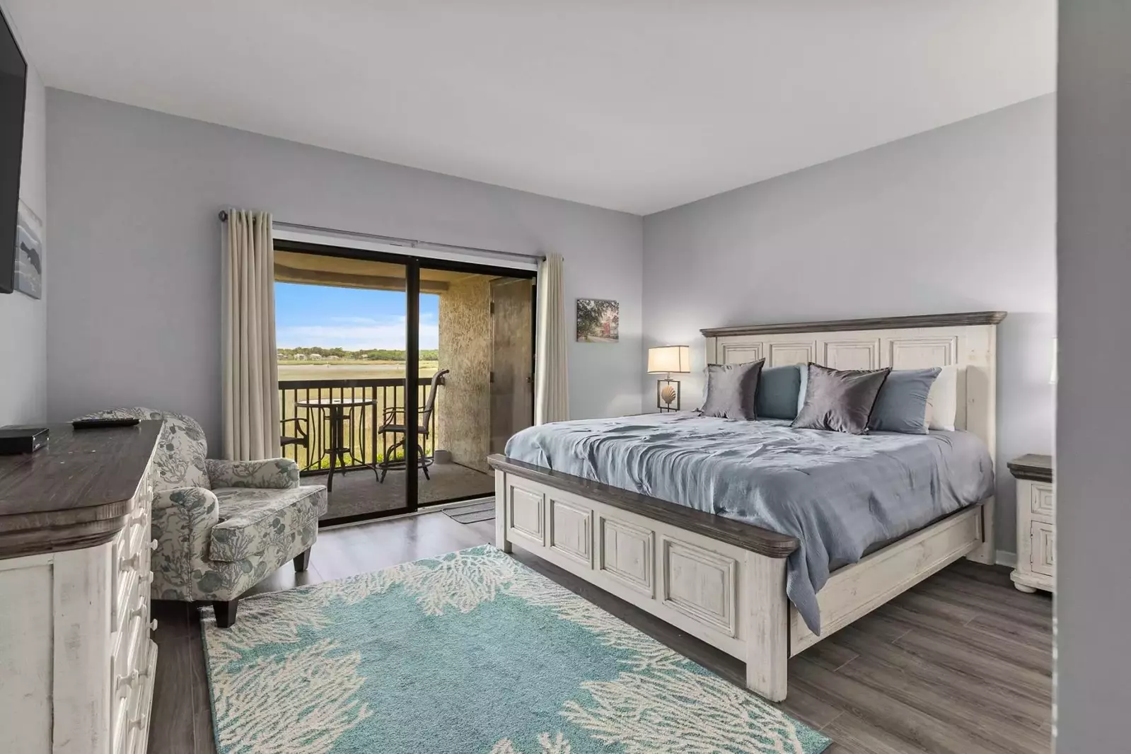 The master suite features a king bed and night stands with reading lamps.