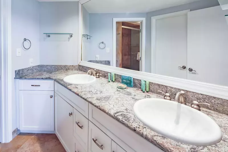 The master suite features an en suite bathroom with a spacious, dual sink vanity.