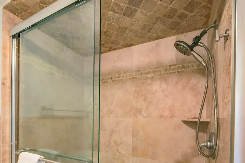 The master bathroom also features a tiled, walk-in shower.