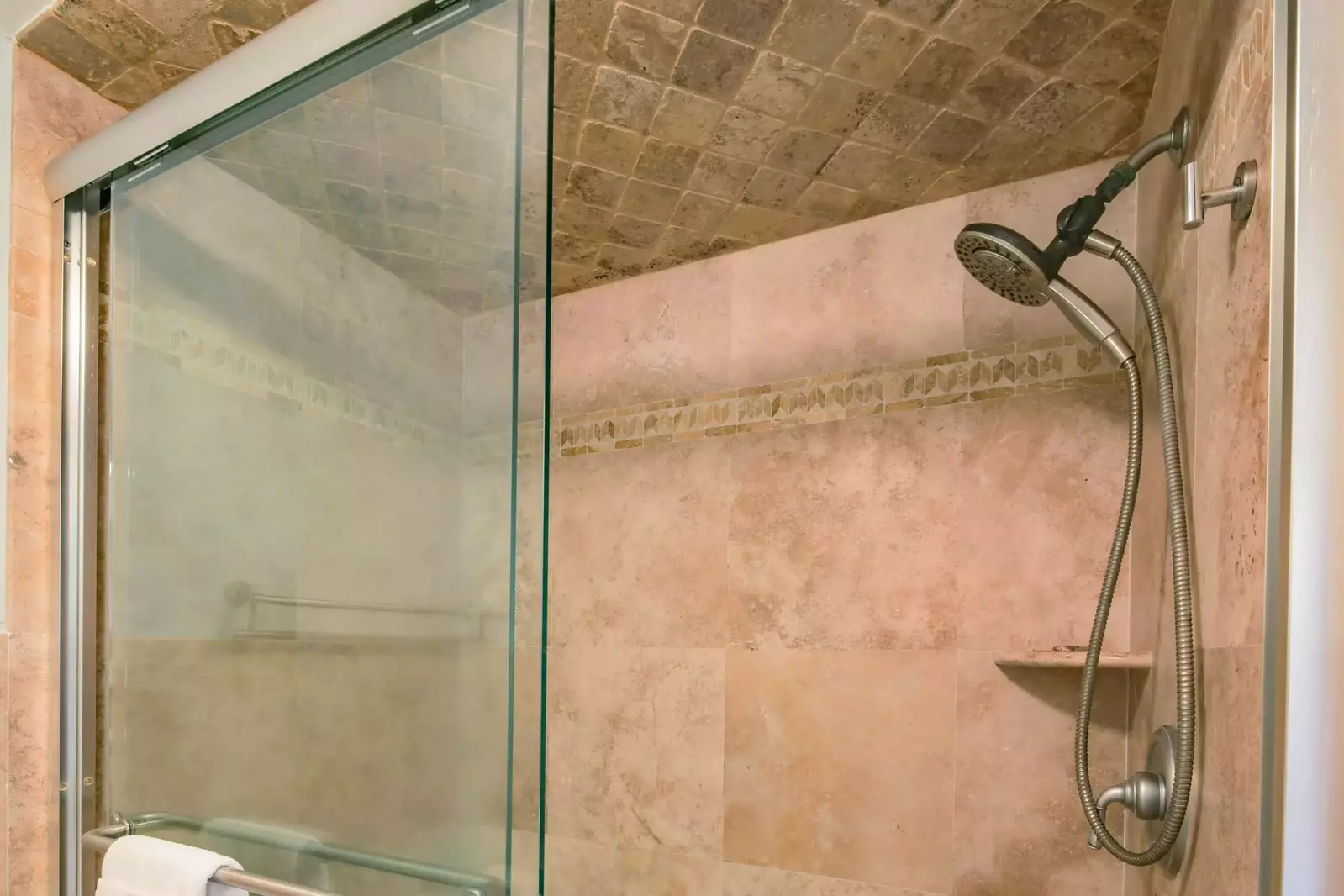 The master bathroom also features a tiled, walk-in shower.