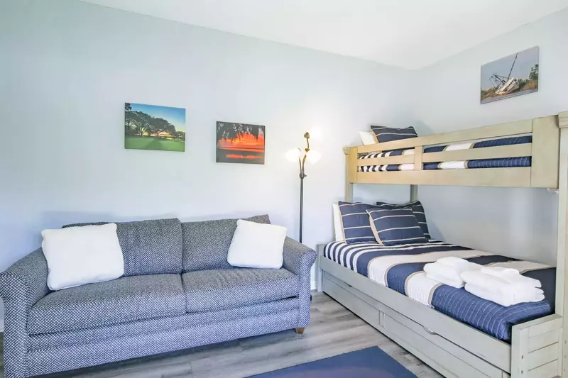 The guest bedroom features a queen sleeper sofa and a bunked twin bed over full bed.