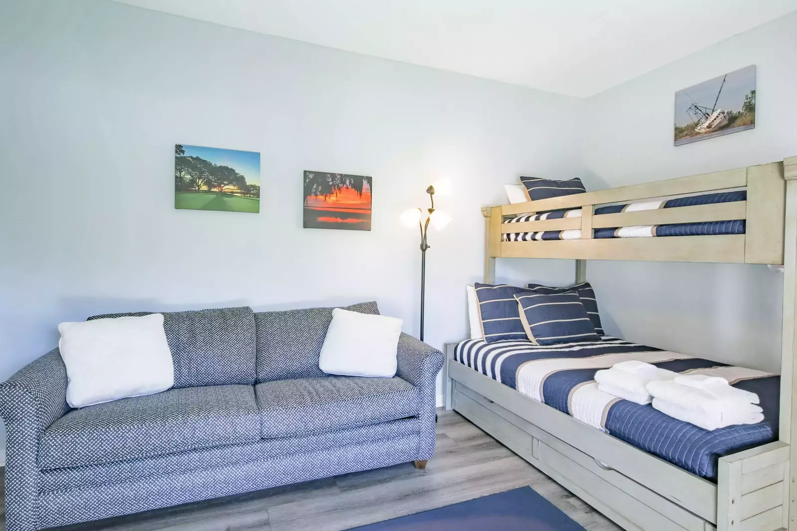 The guest bedroom features a queen sleeper sofa and a bunked twin bed over full bed.