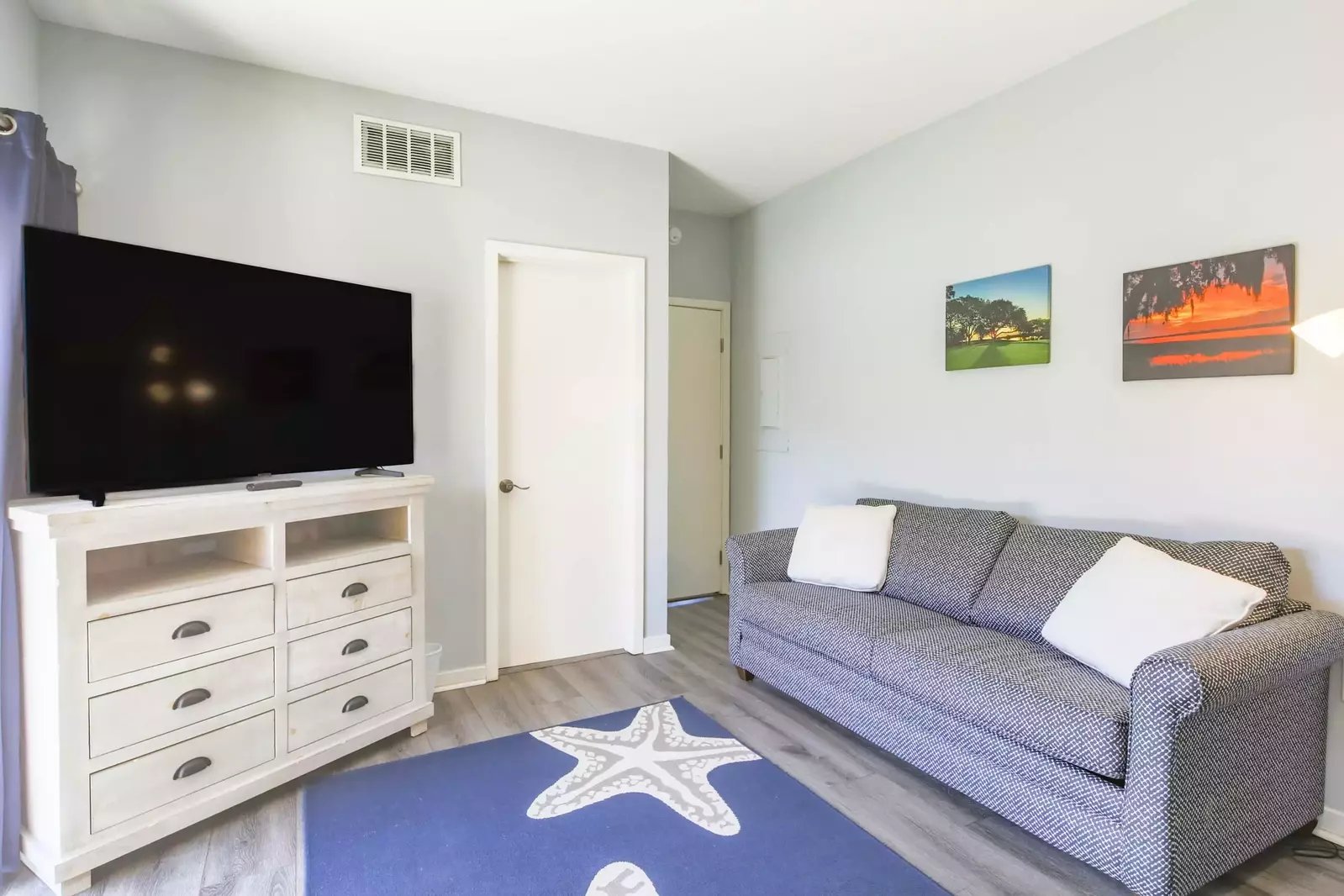 The guest bedroom also features a dresser with large screen TV.