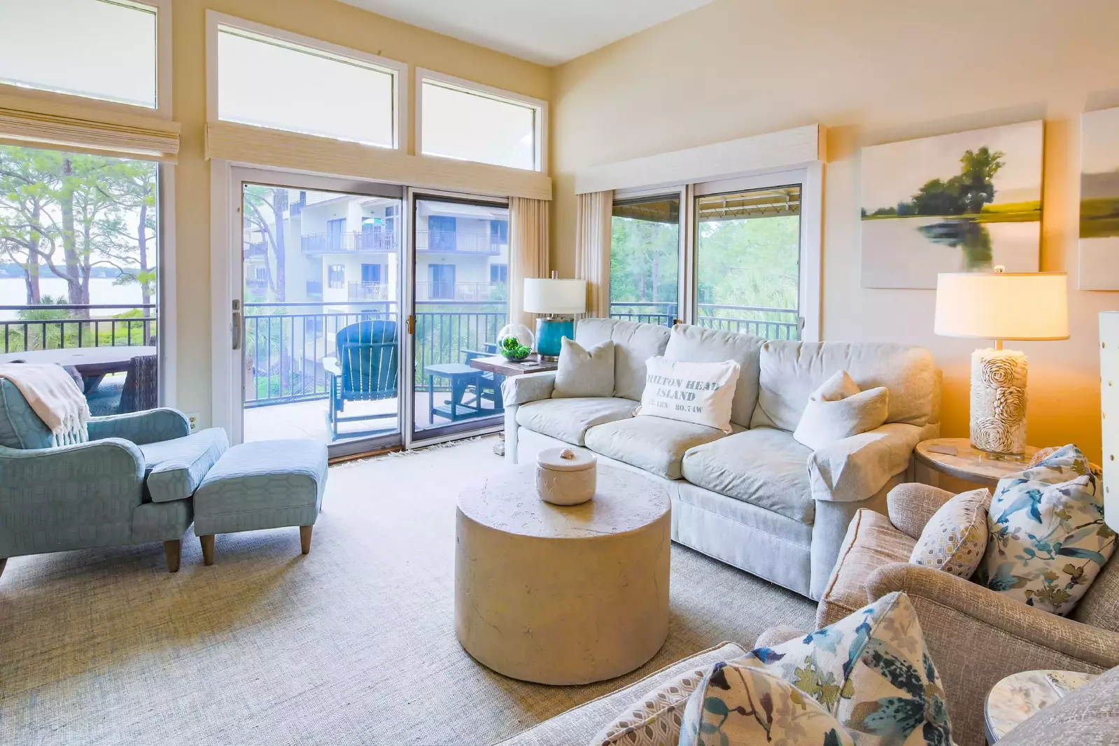 The living room features a spacious seating area and sliding door access to the partially-covered balcony.