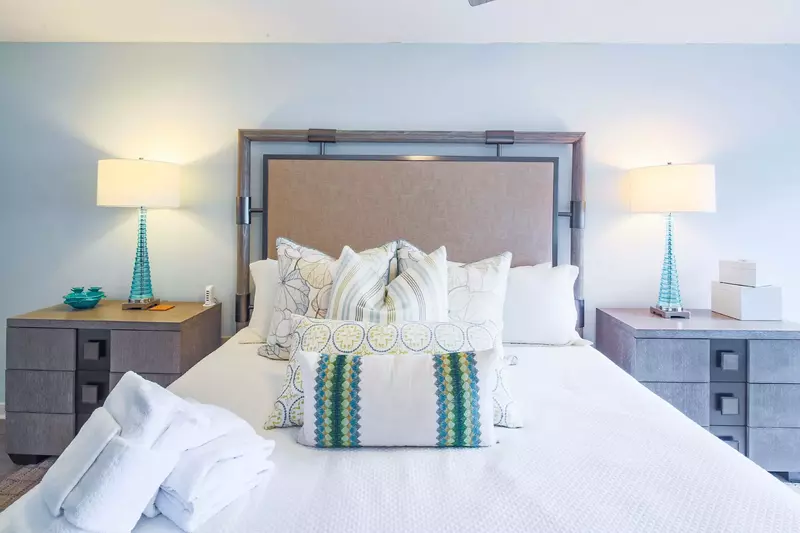 The master suite features a king bed and night stands with reading lamps.