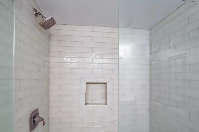 The en suite bathroom also has a tiled, walk-in shower.