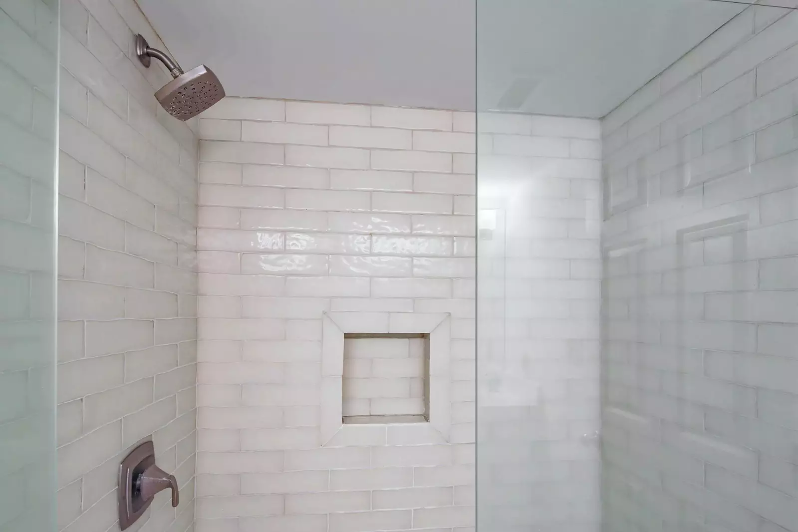 The en suite bathroom also has a tiled, walk-in shower.
