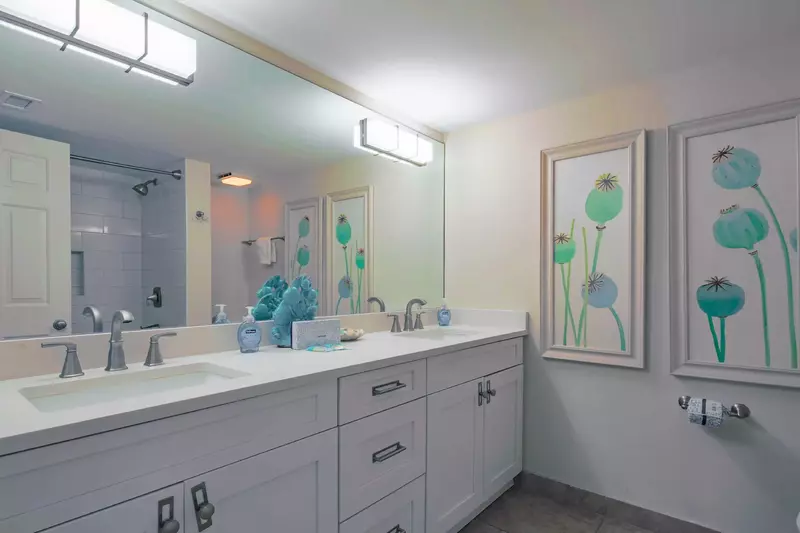The en suite bathroom features a dual sink vanity.