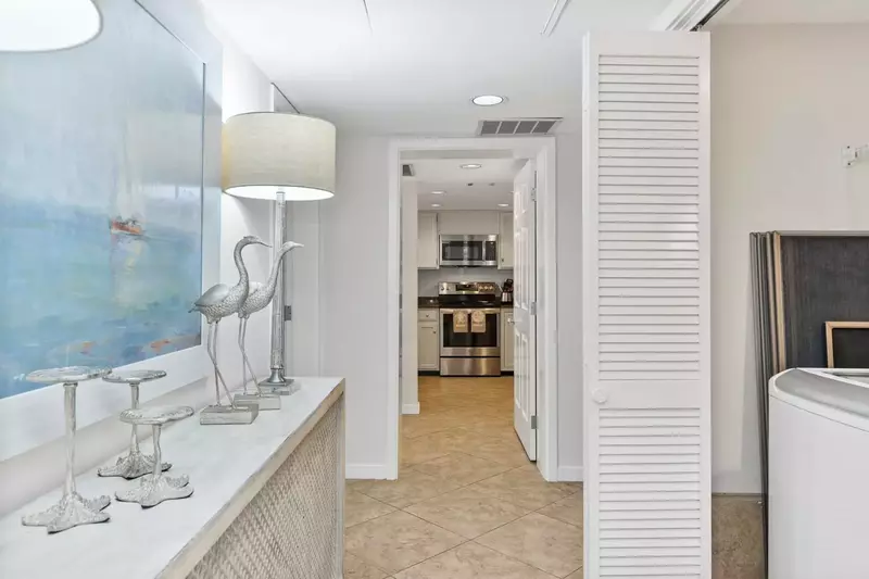 There is a laundry closet in the hallway between the kitchen and master suite.