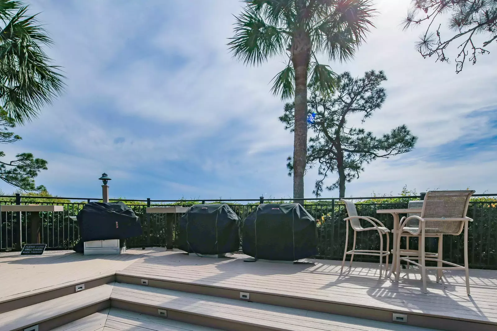 The community grill area features multiple grills and an outdoor dining table.