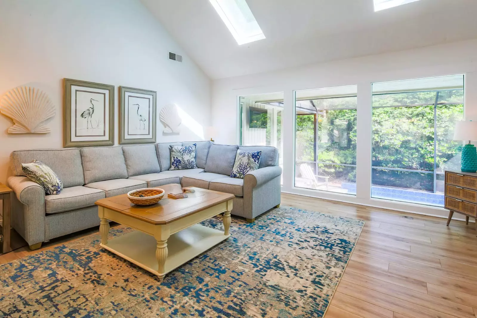 The living room features a spacious seating area and views of the private pool & lanai.