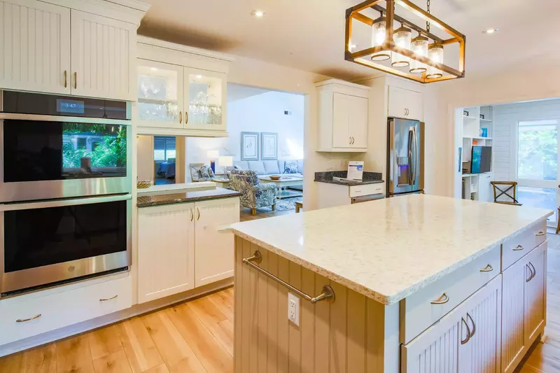 The kitchen also features a stainless steel double oven and refrigerator.