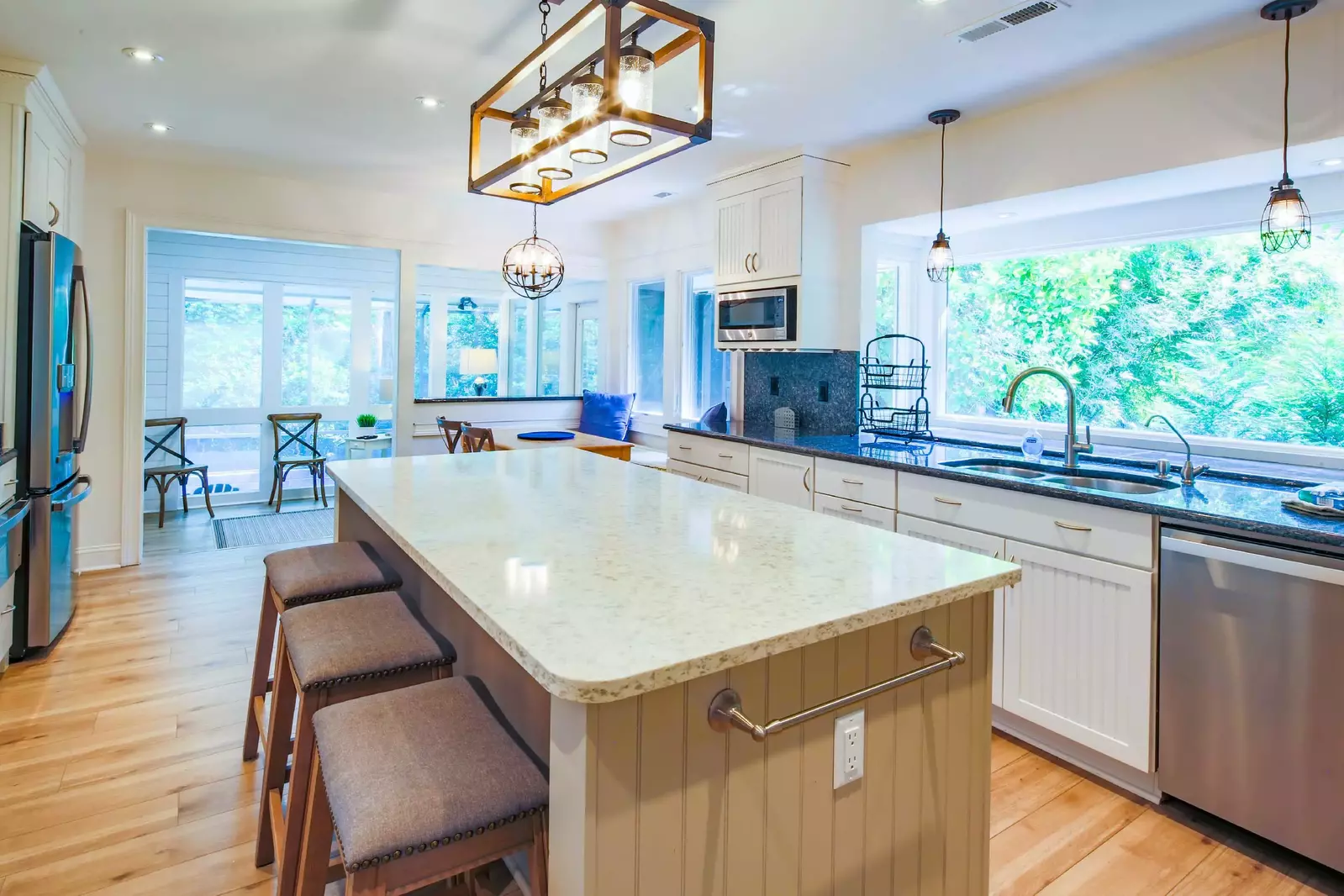 The kitchen also connects to a seating area near the back door to the private pool & lanai.