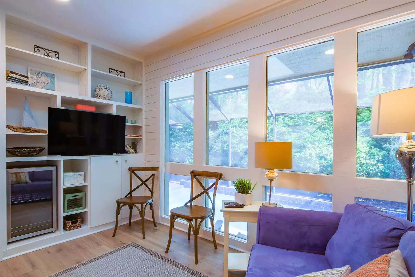 There are built-in shelves & cabinets with a TV and beverage refrigerator.