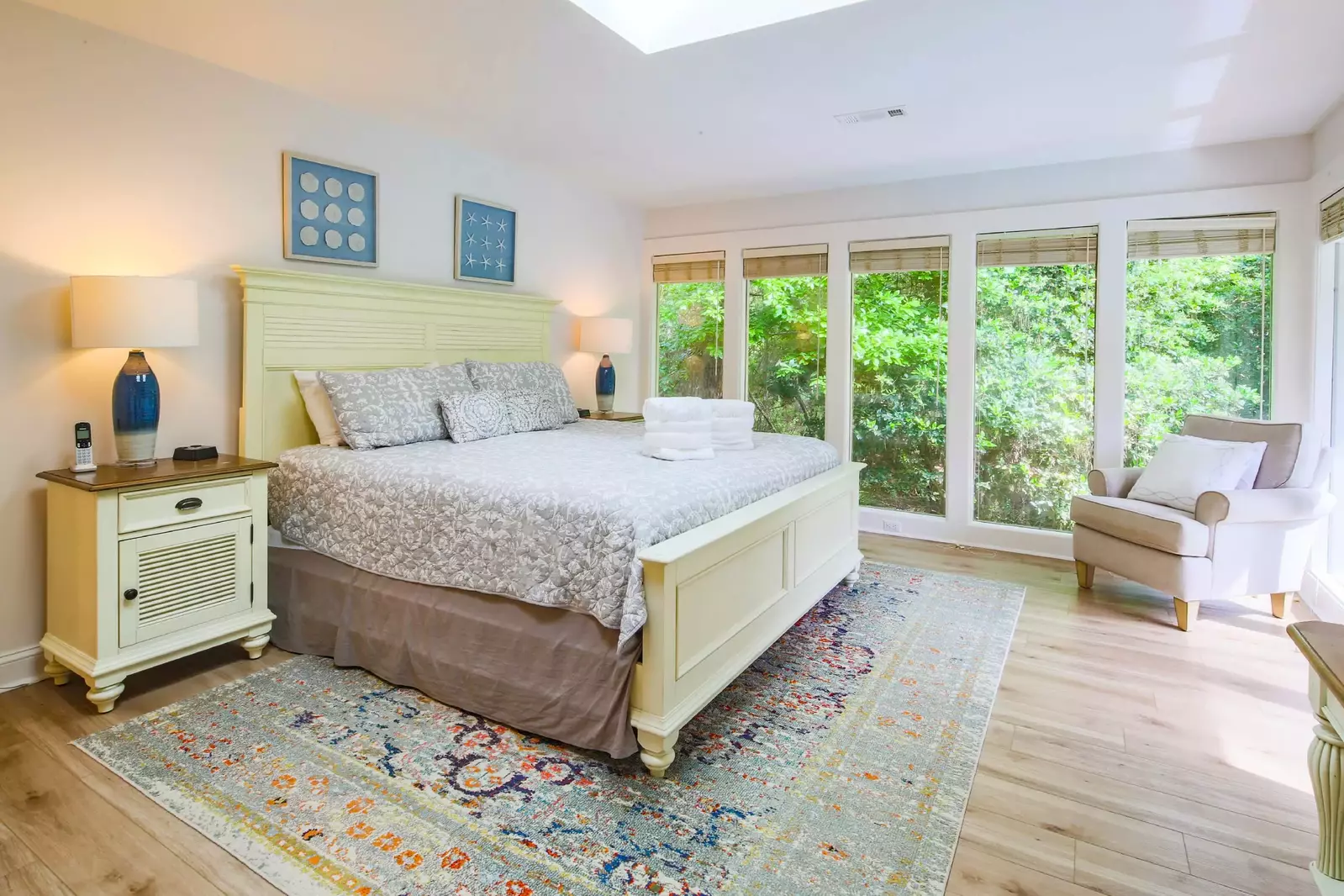 The master suite features a king bed and night stands with reading lamps.