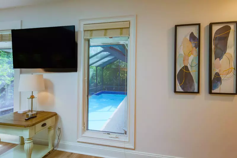 The master suite also features a wall-mounted TV.