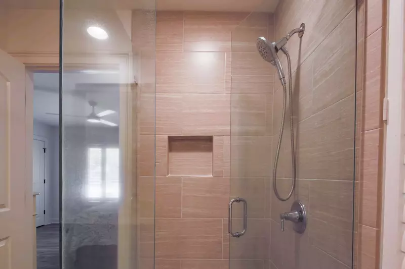 This en suite bathroom also has a tiled, walk-in shower.