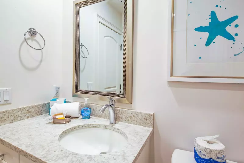This hallway bathroom has a spacious vanity.