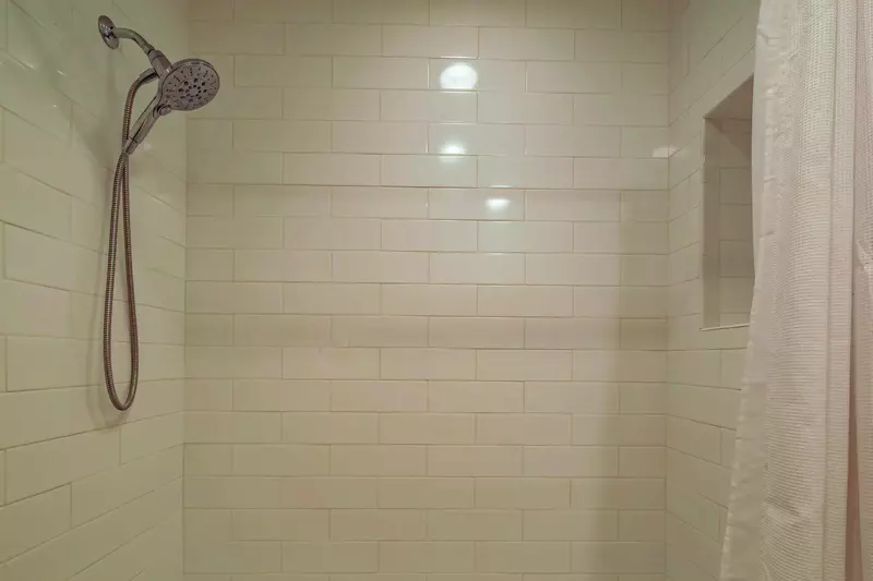The hallway bath also has a tiled shower/tub combo.