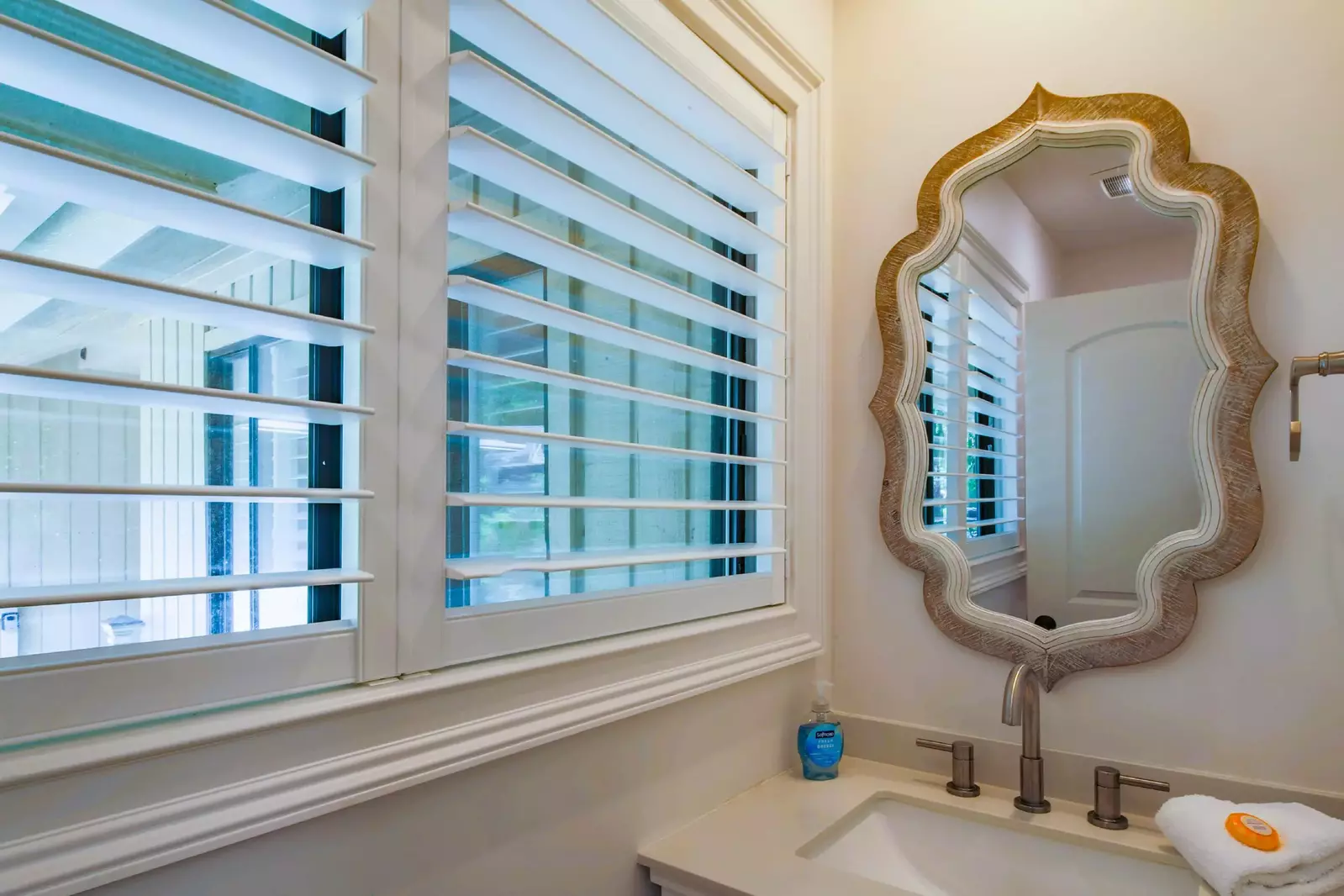 This half bathroom is located near the kitchen and laundry room.