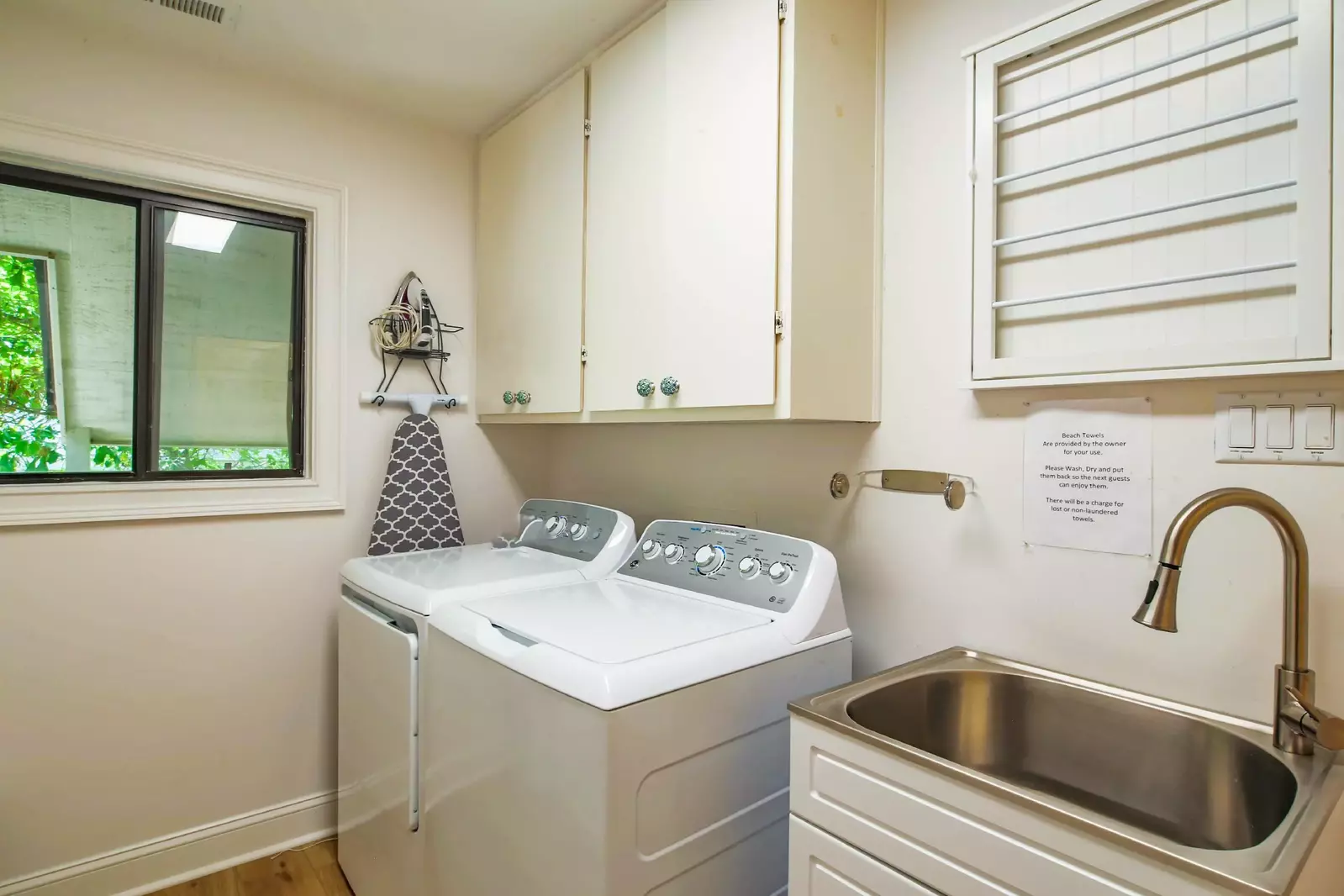 There are a full sized washing machine and dryer in the laundry room.