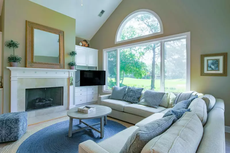 The family room features vaulted ceilings, golf course views and a spacious sectional sofa.